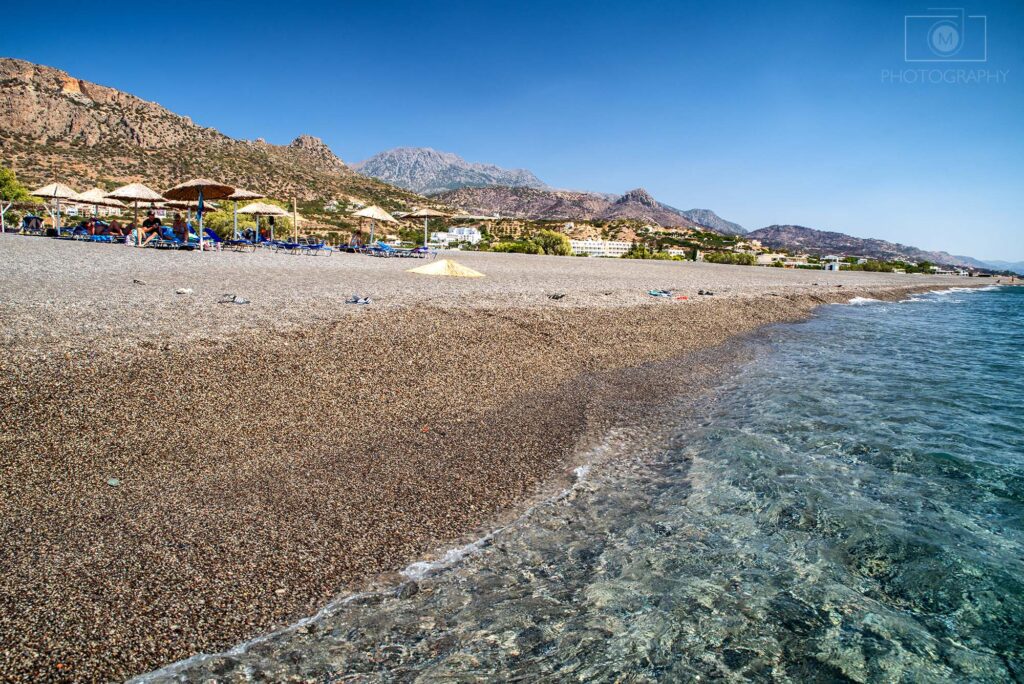 Koutsounari Beach na Kréte pri Ierapetre s dlhou kamienkovou plážou a čistým morom na juhovýchode ostrova
